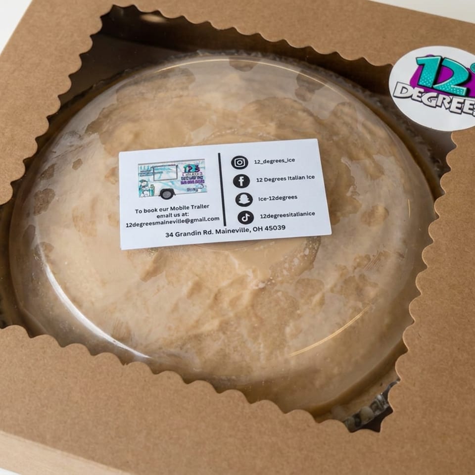 Round frozen dessert in a clear-lidded cardboard box branded 12 Degrees Italian Ice.